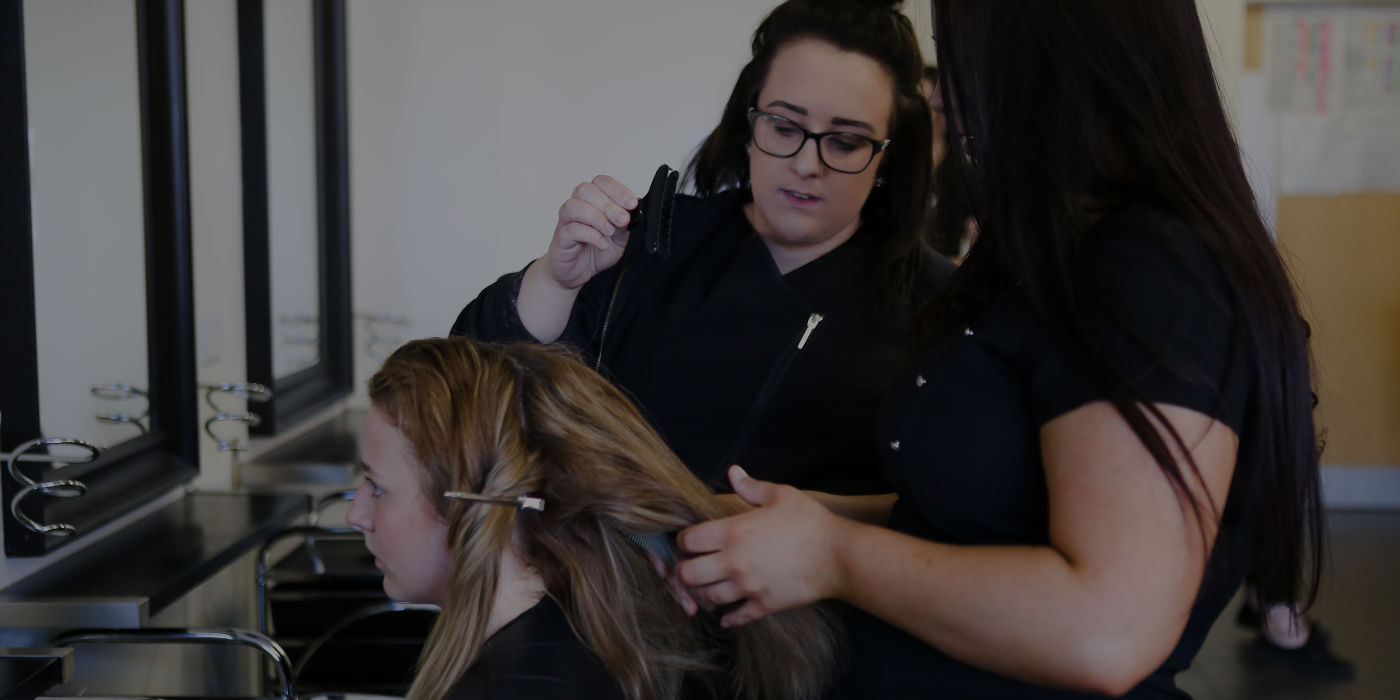 Image of three hairdressing students